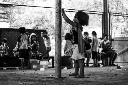 childrens eat breakfast sitting together on bench