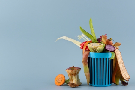 A dustbin with waste vegetables.